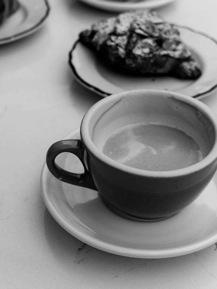 black and white photo of cappucino almond croissant