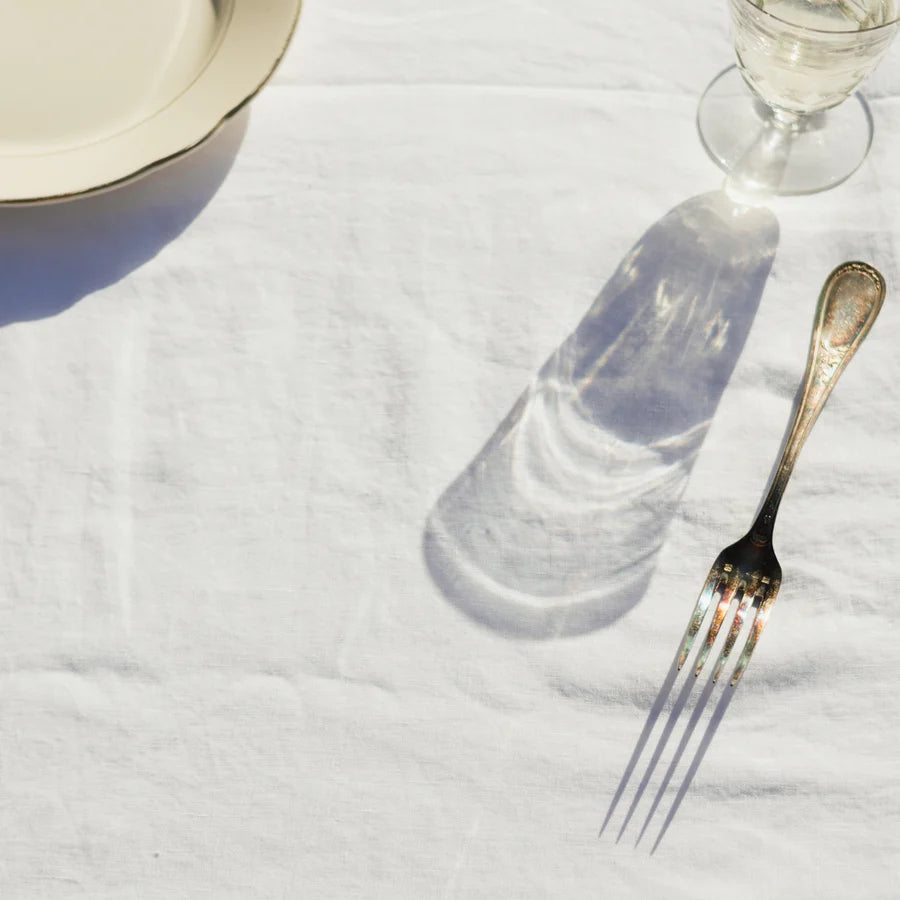 white tablecloth with vintage glass plate fork