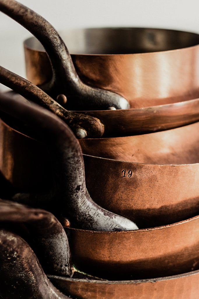 stack of copper pots