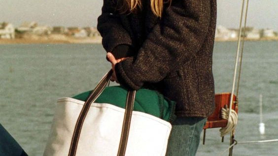 woman on boat with weekender tote