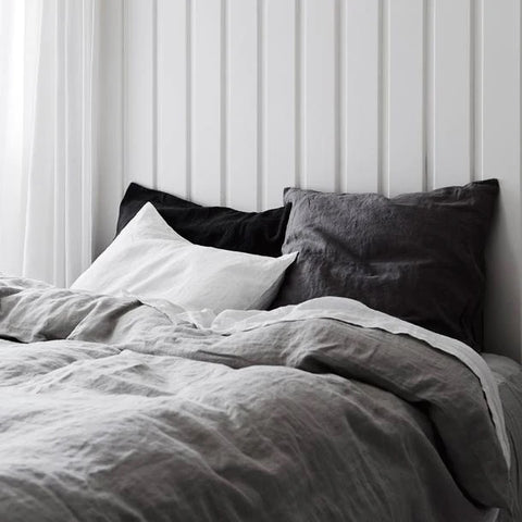 white bedding with velvet pillows