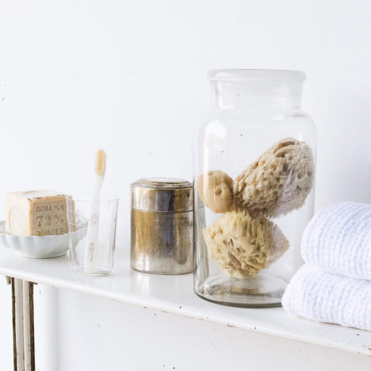 bath shelf with soap sponges and towels